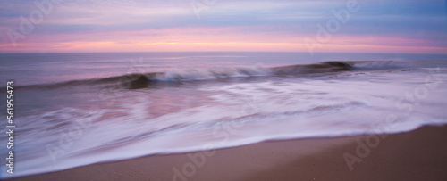 Crashing wave at dawn in Cape Henlopen State Park, Delaware, USA. photo