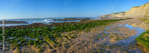 Magoito Beach, beautiful sandy beach on Sintra coast, during low tide, Lisbon district, Portugal, part of Sintra-Cascais Natural Park with natural points of interest