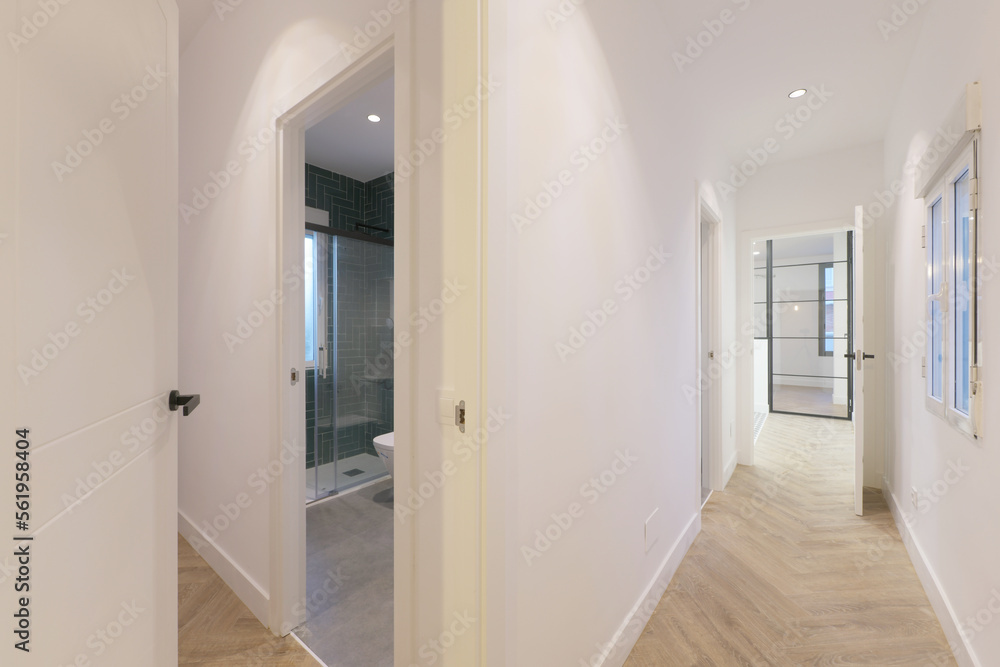 Corridors of a house with access to several rooms with wood-like stoneware floors Corridors of a house with access to several rooms with wood-like stoneware floors