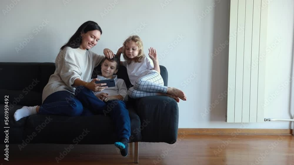 happy mom and 2 kids are calling video call, at home on the couch. empty space happy mom and 2 kids are calling video call, at home on the couch. empty space