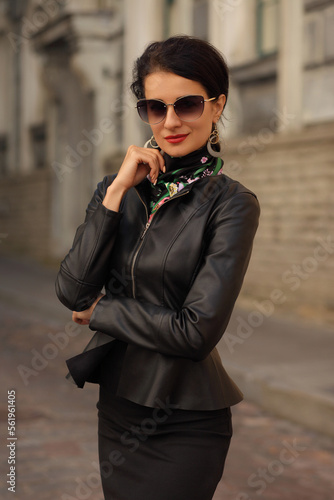 young fashion woman in black clothes in european city