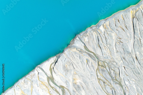 Drone view of the azure lake in the glacier valley. View of the moraines. Landscape from the air.  River on a moraine. Landscape from drone. Abstract view for wallpaper. Alberta, Canada.