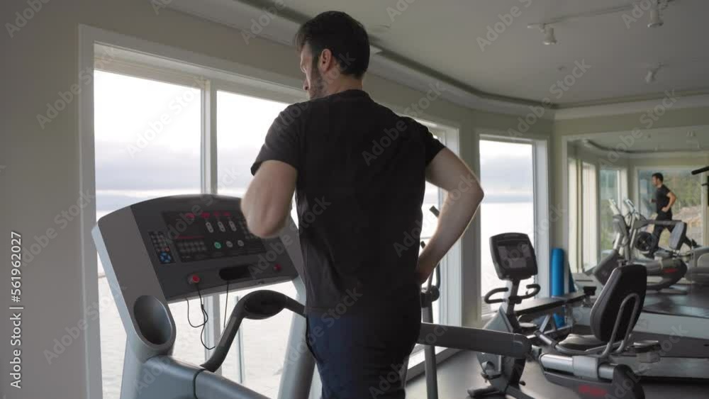 Man running on a treadmill at the gym, physical fitness, working out, determined, getting in shape. 4K 24FPS Man running on a treadmill at the gym, physical fitness, working out, determined, getting in shape. 4K 24FPS
