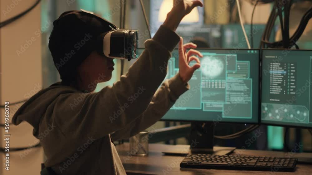Male spy planting virus with vr headtset at night, using virtual reality to hack government database. Dangerous hacker doing cyber espionage on dark web, illegal harassment. Handheld shot. Male spy planting virus with vr headtset at night, using virtual reality to hack government database. Dangerous hacker doing cyber espionage on dark web, illegal harassment. Handheld shot.