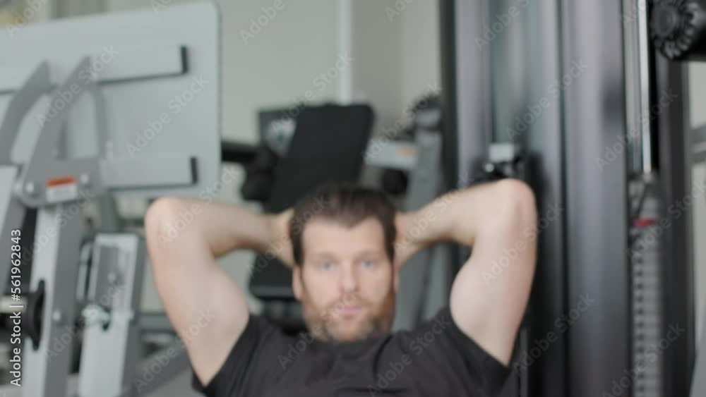 Man doing sit ups at the gym, physical fitness, ab crunches, working out, determined, getting in shape. 4K 24FPS Man doing sit ups at the gym, physical fitness, ab crunches, working out, determined, getting in shape. 4K 24FPS