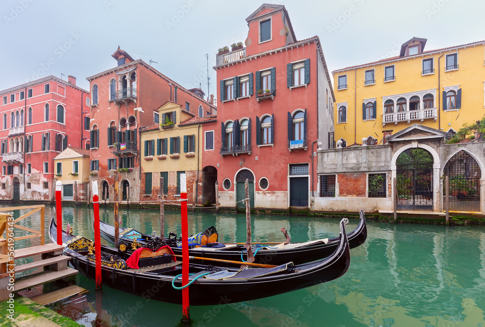 Traditional colorful Venetian houses along the canal at sunset.