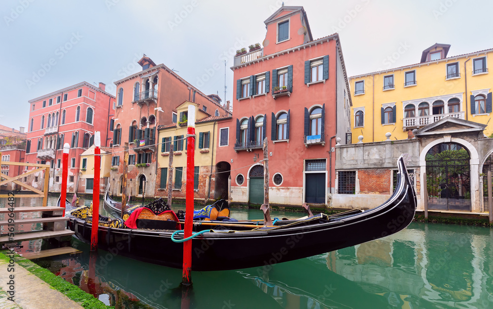 Traditional colorful Venetian houses along the canal at sunset.