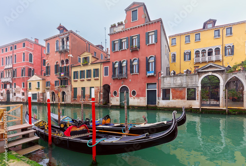 Traditional colorful Venetian houses along the canal at sunset. © pillerss