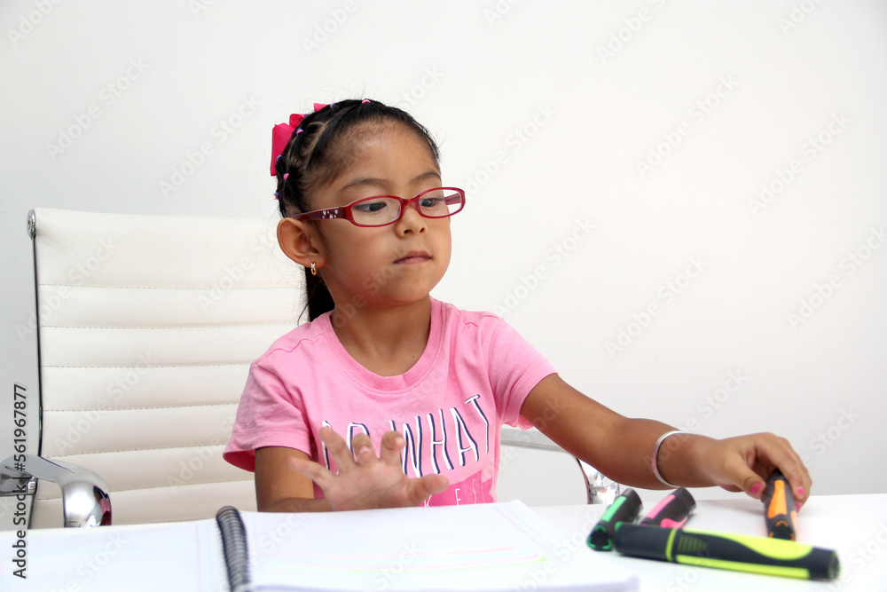4-year-old brunette Latina girl with autism spectrum disorder ASD like Asperger, Rett and Heller draws at a desk, plays with colors alone antisocial 4-year-old brunette Latina girl with autism spectrum disorder ASD like Asperger, Rett and Heller draws at a desk, plays with colors alone antisocial