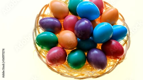 Easter eggs.hand puts an egg in a basket with painted eggson a white background. Easter food. Spring religious holiday symbol. Easter tradition.4k footage photo