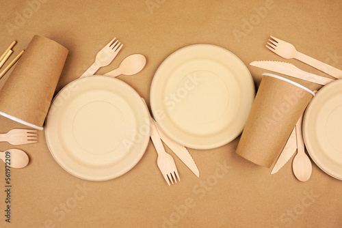 Eco friendly disposable dishware for takeout. Top view scene on a brown paper background. Biodegradable, composable alternative to plastic. photo