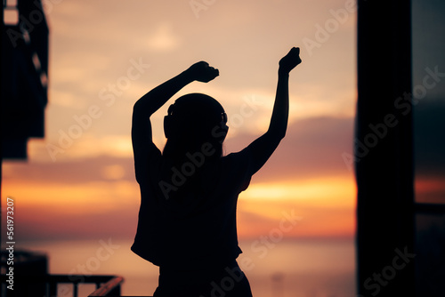 Happy Woman Dancing in the Sunlight Listening to Music. Cheerful girl having fun exercising in the morning. 