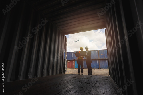 silhouette Group of staff workers standing and checking the containers box from cargo ship for export and import
