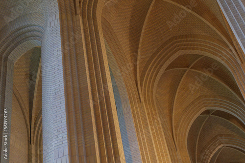 Detail of cream brick vault, arch, rib wall, column and clerestory element on the ceiling of expressionist protestant church in Copenhagen, Denmark.  photo