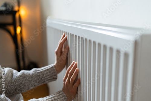 Photos Closeup of woman in woolen sweater wants to keep warmth in apartment