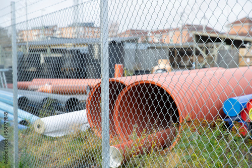 Construction pipe behind fence