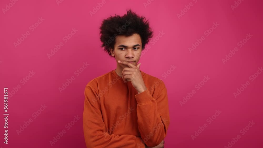 Close-up view of a young guy smiling and looking thoughtful. Portrait of African American man feeling happy when idea coming to his head. High quality 4k footage Close-up view of a young guy smiling and looking thoughtful. Portrait of African American man feeling happy when idea coming to his head. High quality 4k footage