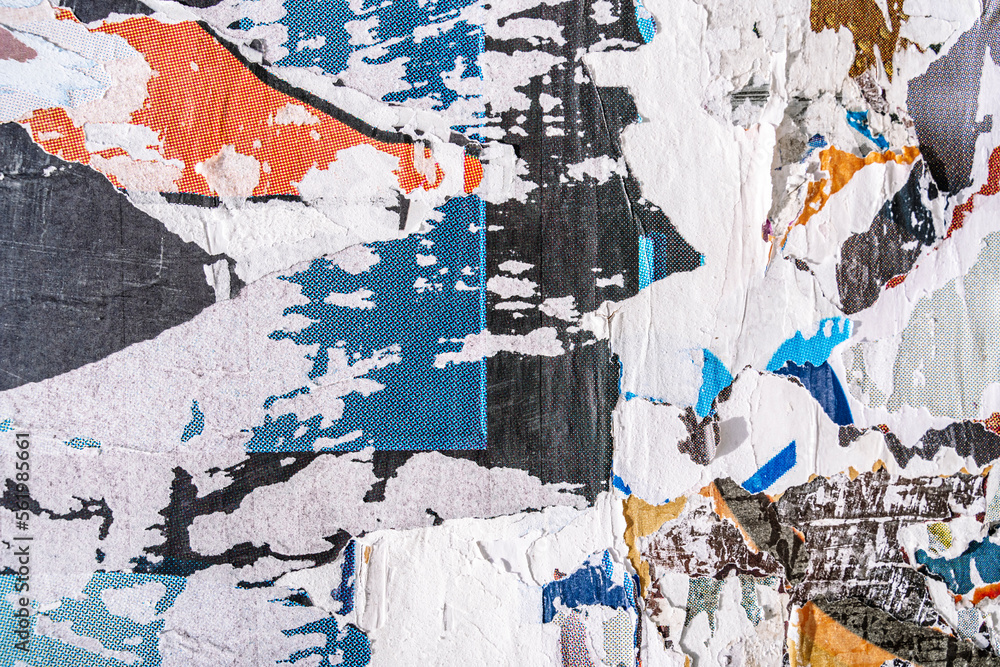 Fototapeta premium Torn paper collage background on an old poster on a street wall. Texture and surface of torn paper.