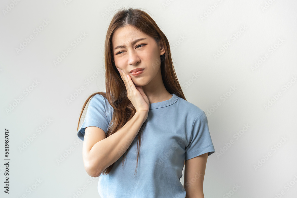 Face expression suffering from sensitive teeth and cold, asian young woman, girl feeling hurt