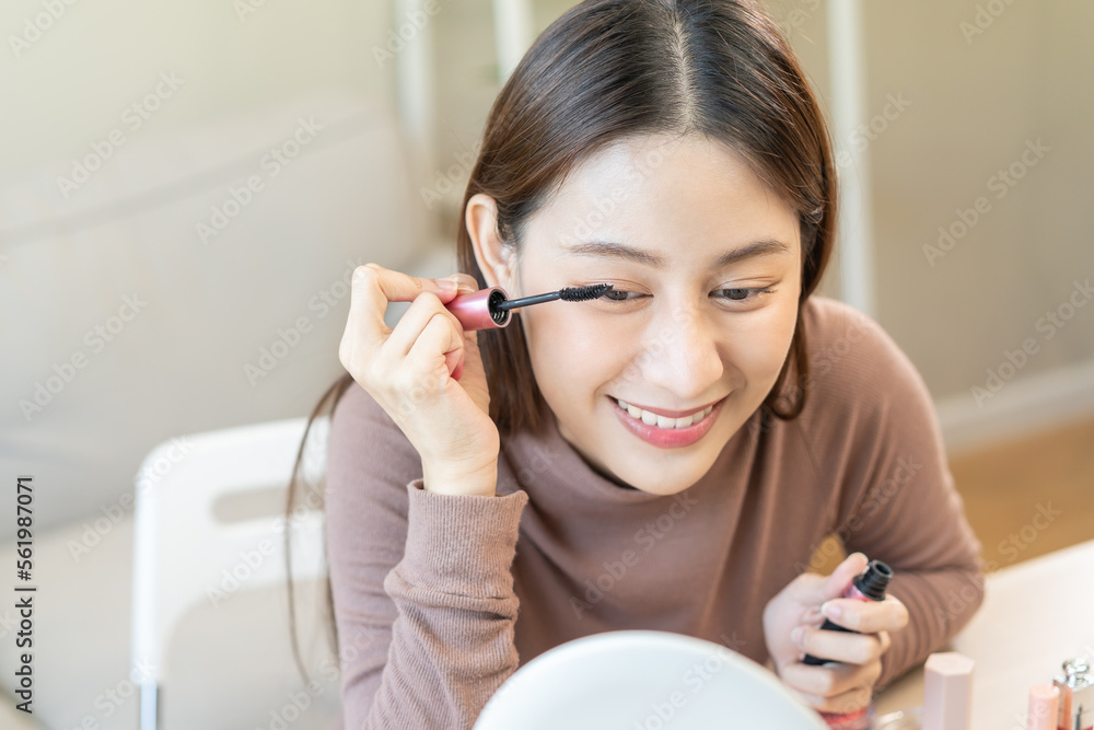 Beauty blogger concept, beautiful and cute asian young woman, girl makeup face by applying brush for eyes on eyebrow, eyeshadow looking at the mirror at home. Female look with natural fashion style. Beauty blogger concept, beautiful and cute asian young woman, girl makeup face by applying brush for eyes on eyebrow, eyeshadow looking at the mirror at home. Female look with natural fashion style.