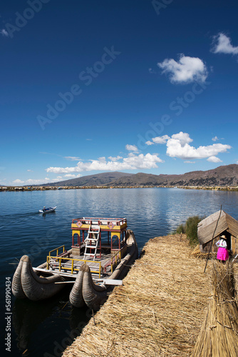 Uros, Peru - Jan 5, 2019. Traditional Totora boat with tourists on Titicaca lake near to the Uros floating islands , Puno, Peru, South America.