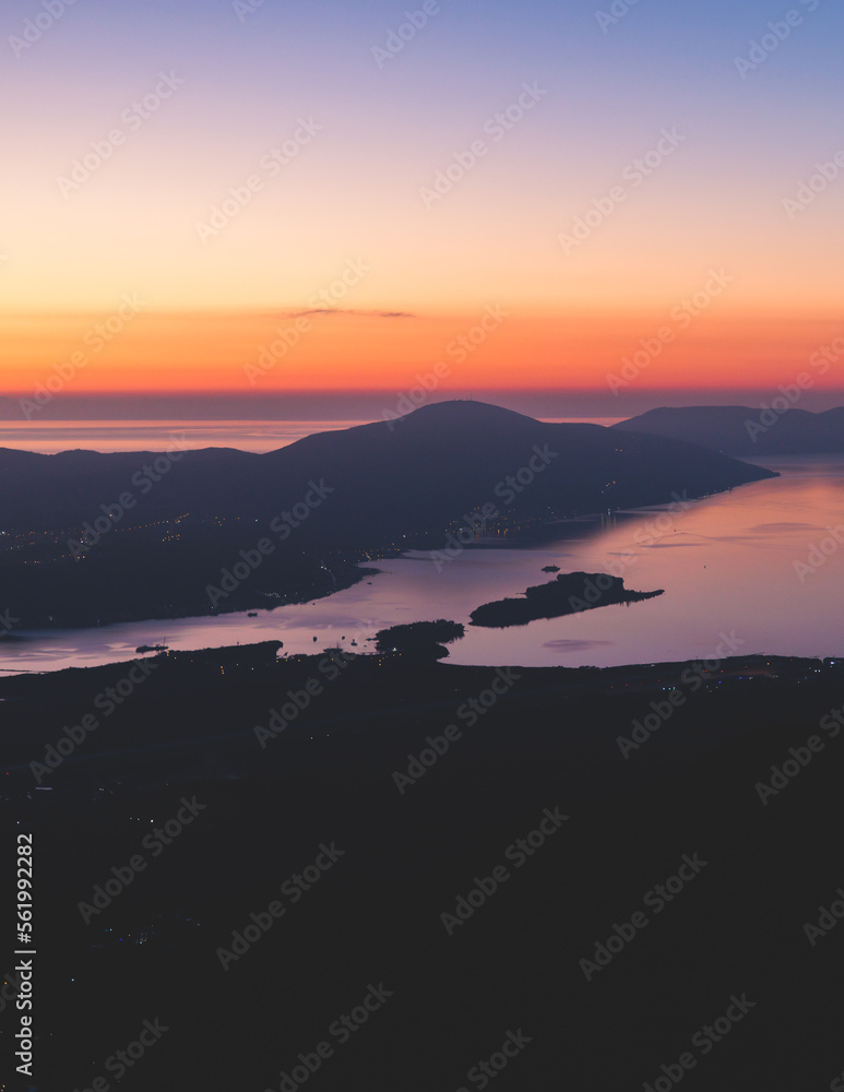 The Bay of Kotor, Beautiful aerial view of Boka Kotorska, with Kotor, Herceg Novi and Tivat municipalities night sunset view, Adriatic sea and Dinaric Alps with Lovcen mountain, Montenegro