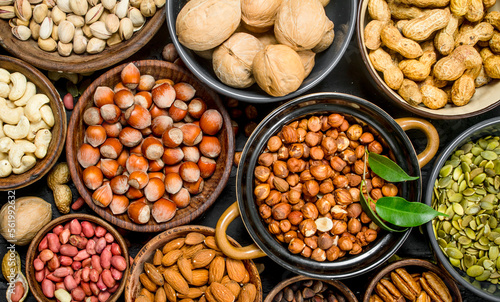 Assortment of different nuts in bowls.