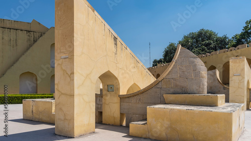 The ancient observatory of Jantar-Mantar. Amazing measuring structures dedicated to the signs of the zodiac are made of sandstone.  Blue sky. Jaipur. India photo