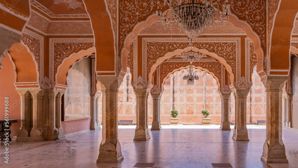 Sarvato Bhadra at Diwan-e-Khas Hall of Private Audience. Columns and openwork arches made of red sandstone are decorated with white ornaments. Chandeliers on the ceiling. India. Jaipur. City Palace