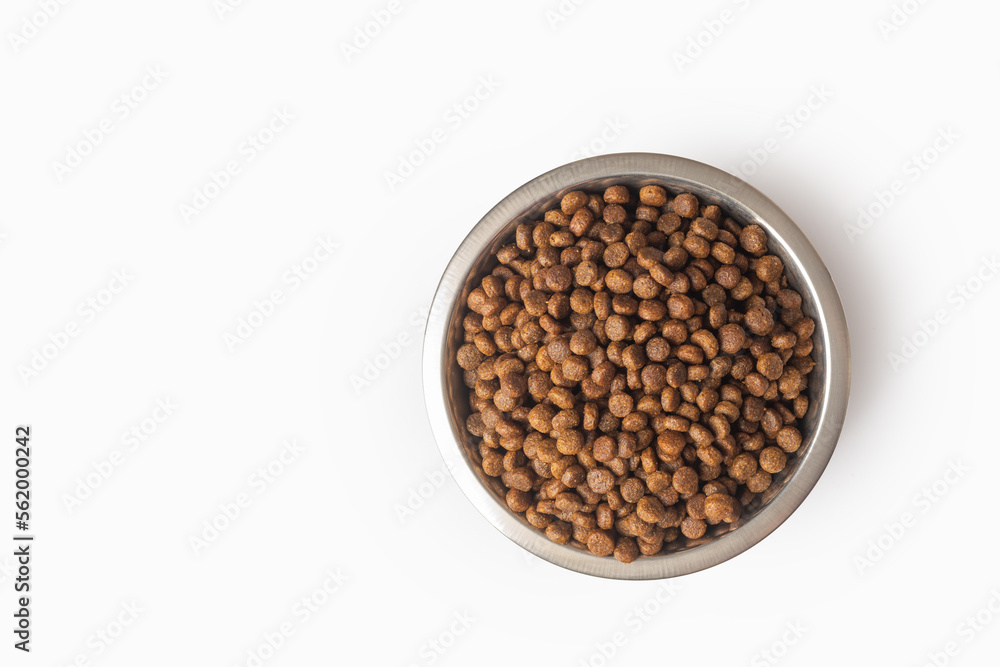dry pet food in a metal bowl isolated on white background. Food for cats and dogs pattern. Pile of granulated animal feeds dry pet food in a metal bowl isolated on white background. Food for cats and dogs pattern. Pile of granulated animal feeds