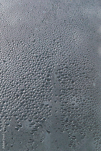 water drops on the window. water drops on glass. rain drops on glass surface. shape of water. texture of bubbles and wet condensation. Macro pattern. Closeup liquid. abstract droplets glass background