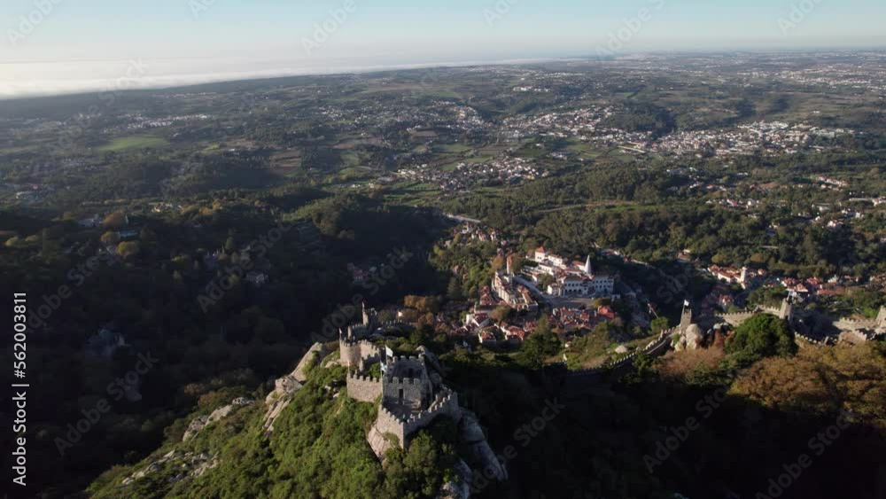Cinematic drone shot flying above ruins of Castelo dos Mouros (Moors Castle) and slowly revealing old town of Sintra and vastness of landscape, Lisbon, Portugal Cinematic drone shot flying above ruins of Castelo dos Mouros (Moors Castle) and slowly revealing old town of Sintra and vastness of landscape, Lisbon, Portugal