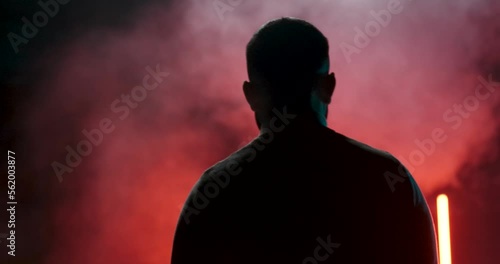 dark man walks through the fog. slow-motion footage. photo