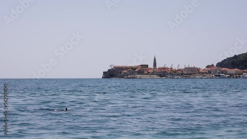 Scuba diver in the sea, in the background the Old Town