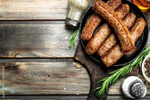 Grill sausages with spices and herbs .