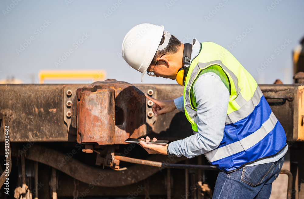 Engineer man working in cargo train platform, Technician checking the freight car, Professional technician pre-check freight trains, Safety concepts