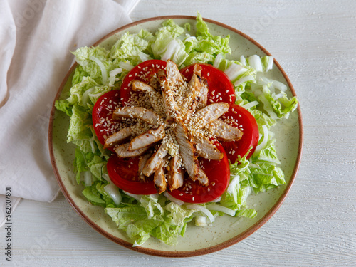 Healthy Homemade Sesame Salad with Chicken Tomato and Chinese cabbage. Top view flat lay photo