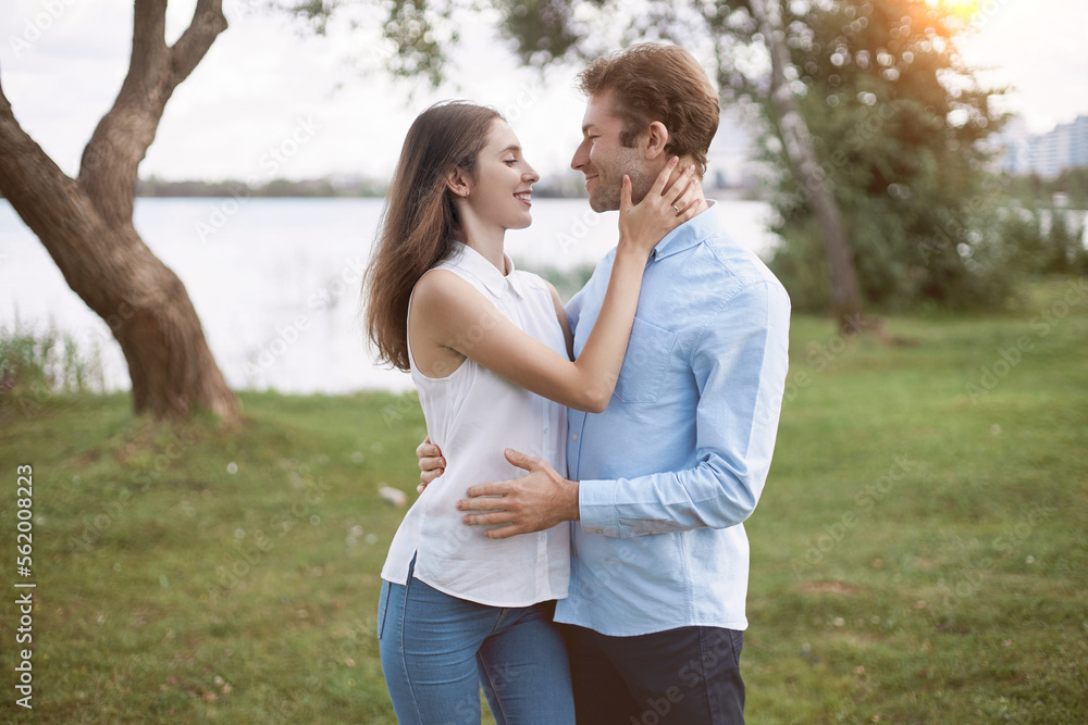 man and a woman in love tenderly looking at each other .