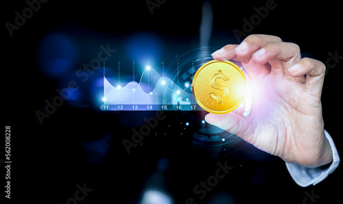 Businessman hand holding coin, growth graph and progress of business and analyzing financial and investment data, business planning and strategy on city background.