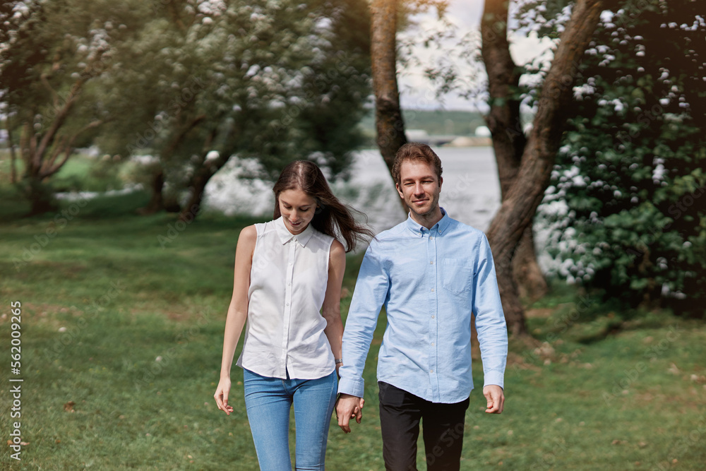 couple in love standing walking along the shore of the lake. couple in love standing walking along the shore of the lake.