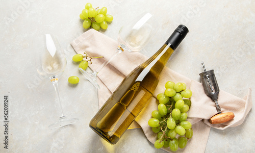 фотографія Glasses and bottle with white wine on a white background.