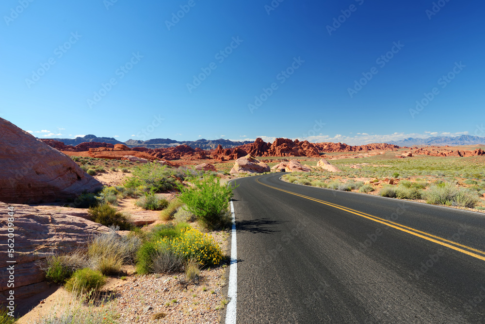 A road leading through sandstone formations in Valley of Fire State Park, Nevada, USA. A road leading through sandstone formations in Valley of Fire State Park, Nevada, USA.