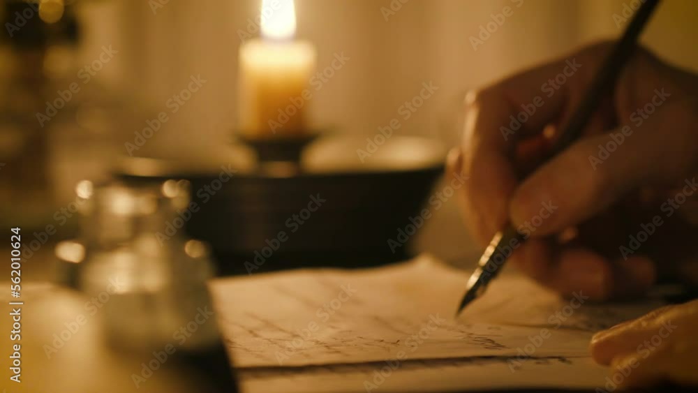 19th century man writing at his desk with a dip pen and ink