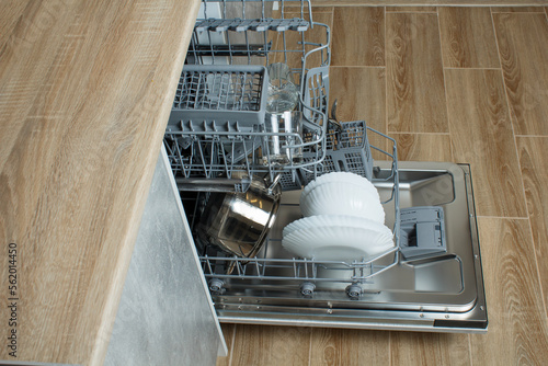 dishwasher in the kitchen. open dishwasher door. modern built-in kitchen appliances