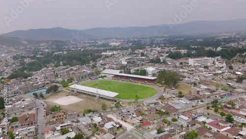 Wide aerial flyover of a small soccer stadium in Huehuetenango, Guatemala. photo