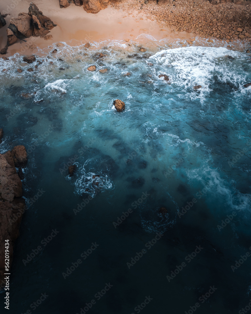 Portugal Ursa Beach, atlantic coast of Atlantic Ocean with rocks and sun waves and foam at sand of coastline picturesque landscape drone aerial photo