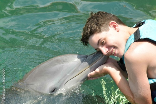 man kissing dolphin