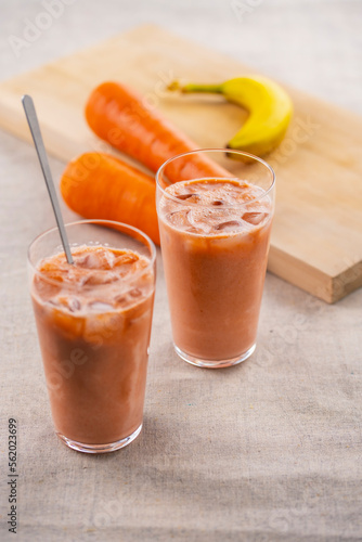 Banana and Carrot smoothie on a table.
fresh smoothie image.
