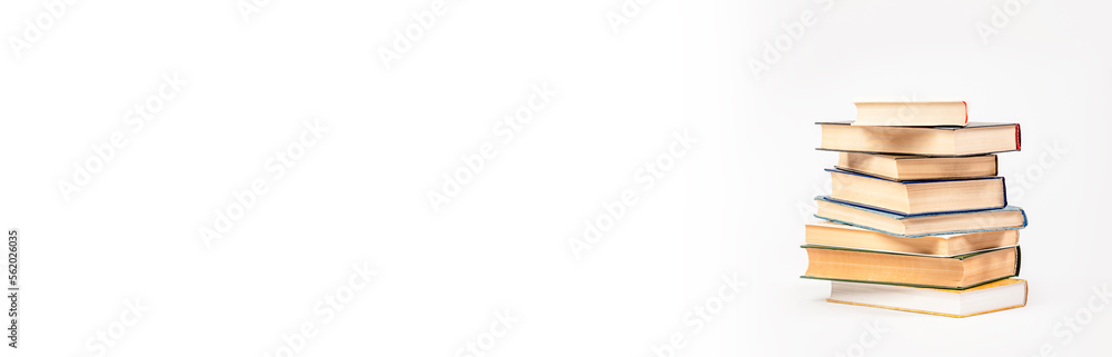 A stack of books on a light background. The concept of reading a paper book, learning. A stack of books on a light background. The concept of reading a paper book, learning.