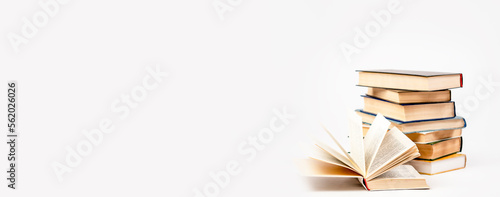 A stack of books on a light background. The concept of reading a paper book, learning.